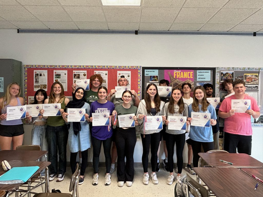 French 3 Honors students celebrate successful scores on their exams.
