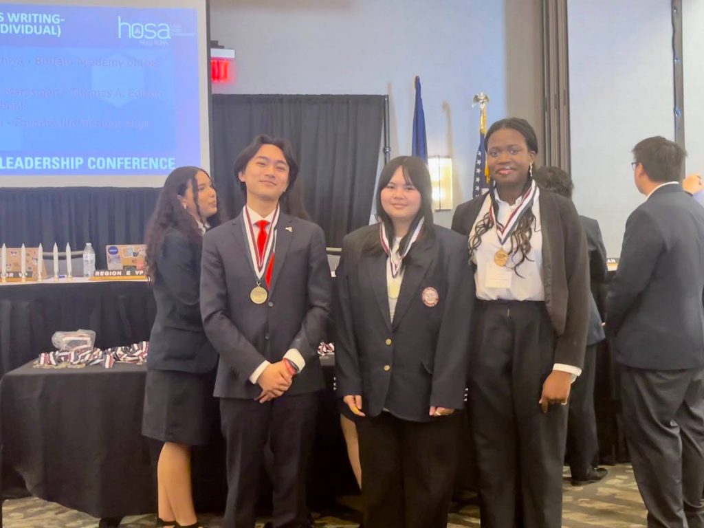 Riley Qian (left) wins a gold medal in Extemporaneous Writing - Health Policy.