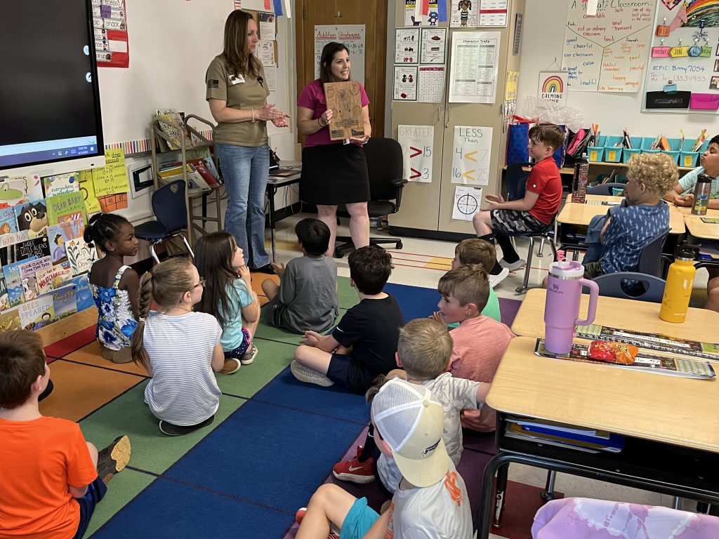 Mrs. Merritt's second grade class was awarded a plaque from Navy Reservist Jessica Serafin for their work in sending letters to military members overseas.