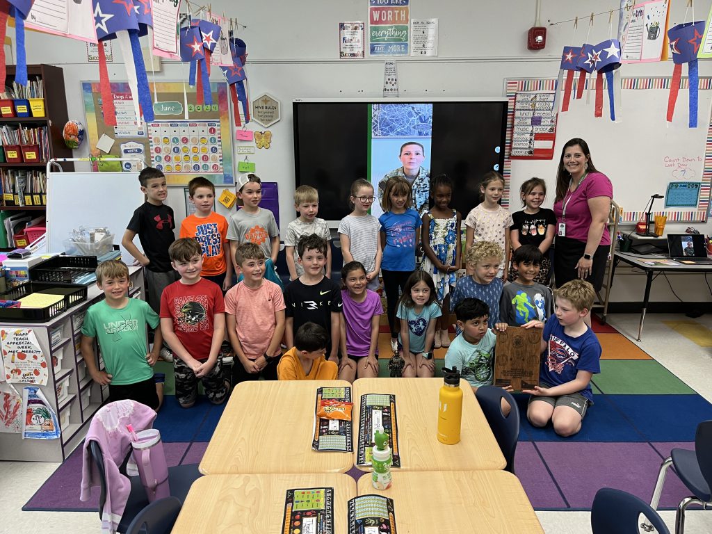 Mrs. Merritt's second grade class was awarded a plaque from Navy Reservist Jessica Serafin for their work in sending letters to military members overseas.