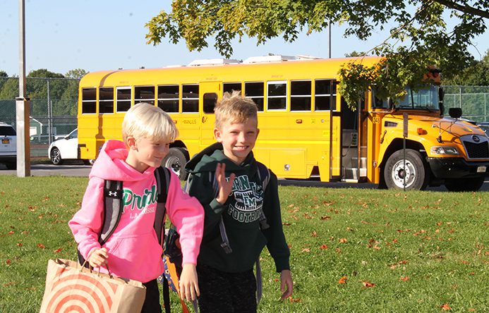 Enders Road Elementary School students walk from the bus into school on the first day of classes, Sept. 3, 2024.