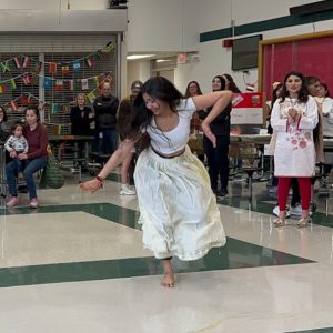 a girl dancing barefoot in the cafeteria as people watch